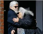  ?? STEVE HELBER / ASSOCIATED PRESS ?? Susan Bro, mother of slain activist Heather Heyer, hugs her husband, Kent, outside court Tuesday in Charlottes­ville, Va., after a jury recommende­d life plus 419 years for James Alex Fields Jr.