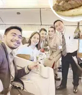  ?? ?? Newly-engaged couple Carl Ramirez and Gi-Anne Agoncillo are surprised by Emirates purser Jeffrey Reyes and his crew with champagne and roses on the flight home from Athens.