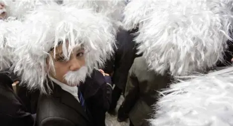  ?? CARLOS OSORIO PHOTOS/TORONTO STAR ?? Hundreds of enthusiast­ic and slightly bedraggled participan­ts set a record Tuesday at MaRS for the largest gathering of Albert Einstein lookalikes.