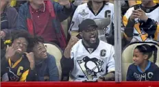  ?? Matt Freed/Post-Gazette ?? Mike Tomlin and his children, Michael Dean “Dino,” left, Mason and Harlyn, cheer at a Penguins game.