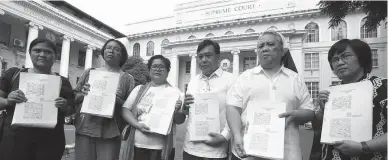  ??  ?? THE PETITION – Human rights advocates and relatives of deceased legislator and labor leader Crispin Beltran yesterday filed a petition for the writs of amparo and habeas corpus data at the Supreme Court to decry threats on their lives, after a hit list...