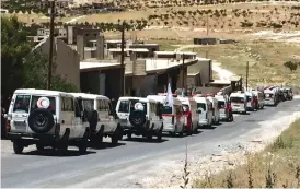  ??  ?? This photo released yesterday by the government-controlled Syrian Central Military Media, shows ambulances of the Syrian Arab Red Crescent gathering in the Syrian border village of Fleeta. —AP