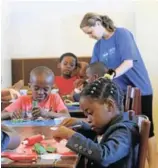  ?? Picture: MADELEINE CHAPUT ?? PLAY AND LEARN: Pupils from Autism Sinethemba preschool have fun with playdough during class, while their teacher assists them