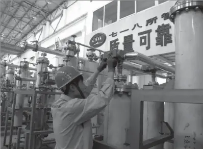  ?? PROVIDED TO CHINA DAILY ?? A worker measures the pressure in a gas tank at a manufactur­ing plant of the 718th Research Institute.