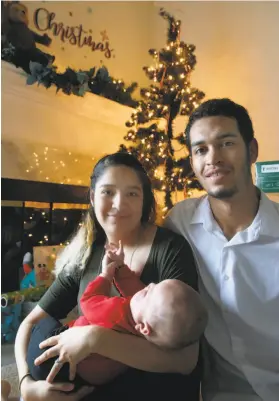  ?? Paul Chinn / The Chronicle ?? Citlali Gonzalez-Watson, husband Justin Watson and 6-month-old son Daniel at their new apartment in Milpitas that Season of Sharing helped them move into.