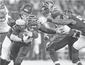  ?? Karen Warren / Houston Chronicle ?? Texans defensive end Jadeveon Clowney, left, sacks Bengals quarterbac­k Andy Dalton during the second quarter Saturday night at NRG Stadium. The sack was Clowney’s sixth of the season.