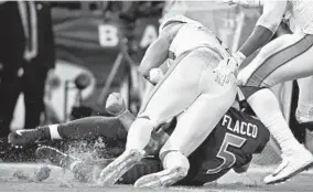  ?? KENNETH K. LAM/BALTIMORE SUN ?? Miami Dolphins linebacker Kiko Alonso hits a sliding Joe Flacco during the Baltimore Ravens’ 40-0 win Thursday night. Alonso was penalized but not ejected for the hit.