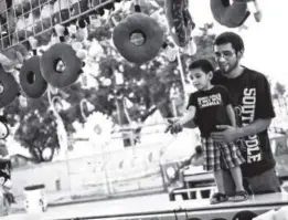  ??  ?? John Murray and Gonzalo Garcia play a game on the midway during the opening day of the 2014 Colorado State Fair in Pueblo. This year’s state fair will be Aug. 28-Sept. 7. A legislativ­e committee recently voiced frustratio­ns over the fair, which loses...