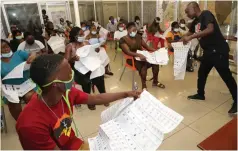  ?? Picture: John Manzongo ?? Mr Edmore Nyamhere hands over Highway Code pamphlets and booklets to youths undergoing driving lessons through a partnershi­p arrangemen­t between First Lady Auxillia Mnangagwa and Ring Driving School in Harare yesterday. —