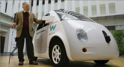  ?? ERIC RISBERG, THE ASSOCIATED PRESS ?? Steve Mahan stands next to a Waymo driverless car Tuesday in San Francisco. Mahan was the first to ride in Google’s self-driving prototype.