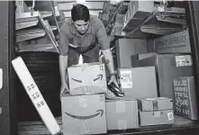  ?? Lynne Sladky / Associated Press ?? UPS employee Liz Perez unloads packages for delivery in Miami in this photo from 2018.