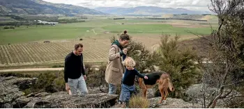  ??  ?? Richie Pearce, Cynarra Ferguson, and son Marley on their property in the Bendigo Hills overlookin­g the likely jet flight path and proposed airport.