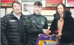  ?? ?? Legendary camogie player, Orla Cotter, making a presentati­on to Fionn O’Connell, in honour of a memorable year for the club in the Premier Junior Hurling Championsh­ip in the presence of Thomas O’Donnell.