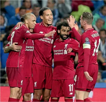  ?? AP ?? Liverpool defender Virgil van Dyk, third from right, celebrates his goal in the 4-1 win over Porto with team-mates Fabinho, left, Mohamed Salah and Jordan Henderson.