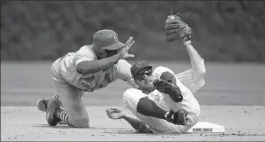  ?? JOHN J. KIM/TRIBUNE NEWS SERVICE ?? Cardinals center fielder Dexter Fowler (25) calls for time as Cubs second baseman Ben Zobrist (18) gets up after Fowler steals second base on Friday at Wrigley Field in Chicago, Ill.