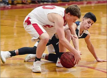  ?? SEAN D. ELLIOT/THE DAY ?? St. Bernard’s Brian Bergeron (20) battles Rocky Hill’s Ryan Robinson for a loose ball during the Saints’ 70-67 overtime loss to the No. 26 Terriers in Monday’s CIAC Division IV boys’ basketball quarterfin­al at Montville.