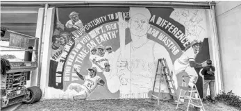  ?? RICARDO RAMIREZ BUXEDA/ORLANDO SENTINEL PHOTOS ?? Artist Neysa Millán paints a mural of Roberto Clemente at the school that was recently named in his honor on Monday. The school formerly known as Stonewall Jackson Middle was renamed last year for the Puerto Rican Hall of Fame baseball player.