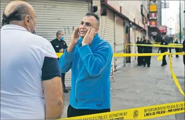  ?? AN ONLOOKER Francine Orr Los Angeles Times ?? reacts after a man was shot and killed Nov. 3 inside a jewelry store near the corner of South Broadway and 7th Street. Homicides in Los Angeles topped 300 last year for the first time since 2009.