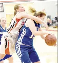  ?? PHOTO BY RICK PECK ?? McDonald County’s Cloee Helm fights over a St. Mary’s Colgan player for a loose ball during the Lady Panthers 39-37 win on Dec. 13 at MCHS.