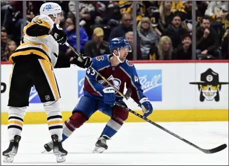  ?? ANDY CROSS — THE DENVER POST ?? Darren Helm (43) of the Colorado Avalanche checks the path of a puck sent across the ice by Brian Dumoulin (8) of the Pittsburgh Penguins in the first period at Ball Arena March 22, 2023.