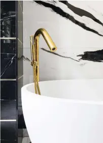  ?? ?? ABOVE ‘A gold trim between the tiles ties in with the gold tap – it’s the attention to detail that makes a room feel finished.’
White bath, £650, British Baths. Marquina wall tiles, £47.93sq m, Al-murad Tiles