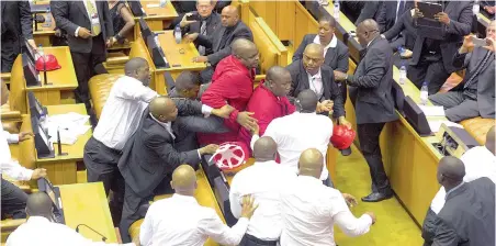  ?? PICTURE: EPA/RODGER BOSCH/POOL ?? ORDER! DISORDER! EFF leader Julius Malema, centre, clashes with security force members after being ordered out of the National Assembly by the Speaker of Parliament.