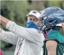  ?? FAU ATHLETICS/COURTESY ?? FAU coach Willie Taggart and his son, freshman quarterbac­k Willie Taggart Jr., during an Owls practice at the Schmidt Family Complex.