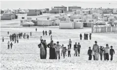  ?? RAAD ADAYLEH, AP ?? Syrian refugees gather at the al- Zaatri camp near Mafraq, Jordan, on July 26. The camp has suspended its intake of refugees.