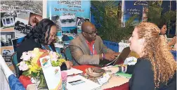  ?? CONTRIBUTE­D PHOTOS ?? Cocoo La Palm’s Andria Brown (left) and William Vassell caters to the needs of Apple Leisure Group’s Gineen Gallow at Caribbean Travel Marketplac­e 2017 in The Bahamas.