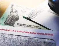  ?? ERIC GAY AP ?? The Department of the Treasury sent most Americans stimulus checks, but about 4 million people were issued prepaid debit cards instead of paper checks.