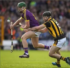  ??  ?? Wexford midfielder Aidan Nolan is tackled by Kilkenny’s Jason Cleere during their National League quarter-final clash in Nowlan Park in April.