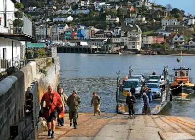  ??  ?? Passengers alight from the ferry at Dartmouth.