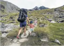  ?? PHOTO: GUILLAUME CHARTON ?? A Queenstown family heads to Lake Alta in the Remarkable­s Conservati­on Area.