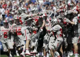  ?? ELISE AMENDOLA —ASSOCIATED PRESS ?? Ohio State goalkeeper Tom Carey (3) jumps with teammates to celebrate their victory over Towson in a Division I lacrosse semifinal May 27 in Foxborough, Mass.