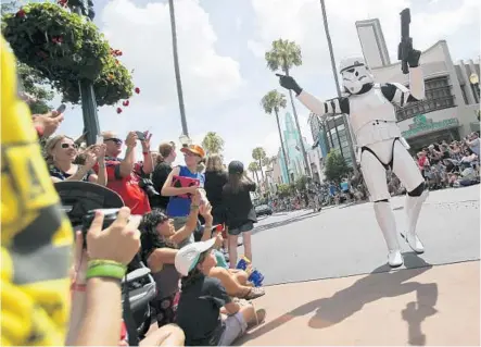 ?? JACOB LANGSTON/STAFF FILE PHOTO ?? “Star Wars” characters in Legends of the Force Motorcade entertain fans at Disney’s Hollywood Studios in May during Star Wars Weekends.