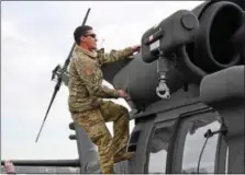  ?? MARIAN DENNIS – DIGITAL FIRST MEDIA ?? Chad Carvalho, 34, shows his family around the Black Hawk he flew into Heritage Field Airport Jan. 10.