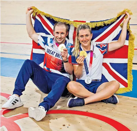  ??  ?? Cyclists Jason Kenny, Britain’s most decorated Olympian with his keirin gold, and wife Laura, the five-time champion who carried the flag into the stadium at the closing ceremony