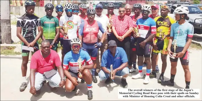  ?? ?? The overall winners of the first stage of the Jagan’s Memorial Cycling Road Race pose with their spoils on Sunday with Minister of Housing Colin Croal and other officials.