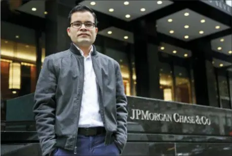  ?? SETH WENIG — THE ASSOCIATED PRESS ?? In this Tuesday photo, Akash Negi poses for a picture in front of his office in New York. Donald Trump says he wants more “merit-based” immigrants as opposed to those who arrive due to family ties, but his administra­tion has taken steps to make life...