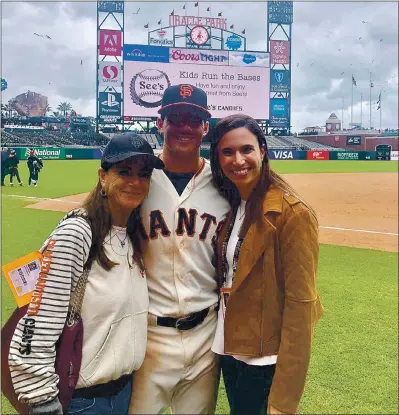  ?? PHOTOS COURTESY OF THE YASTRZEMSK­I FAMILY ?? Anne Marie Yastrzemsk­i, Mike’s mother, and wife Paige Yastrzemsk­i join him on the field at San Francisco’s Oracle Park after Mike’s second game with the Giants on May 26, 2019. The two women refused to let Mike’s dream of major league stardom die of frustratio­n.