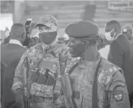  ?? BARBARA DEBOUT/AFP ?? A private security guard from Russia’s Wagner Group, left, stands next to a Central African Republic soldier during a rally March 18 in the capital city of Bangui.