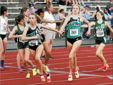  ?? PHOTOS BY STAN HUDY — SHUDY@DIGITALFIR­STMEDIA.COM ?? Julia Zachg hands off the baton to anchor Hannah Reale in the 4x800 relay Saturday at Union-Endicott High School during the New York State Public High School Athletic Associatio­n track and field championsh­ips.