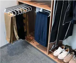  ?? Cuisinella ?? Ci-contre. Pour que chaque chose soit à sa place et faciliter le choix au quotidien, des rangements spécifique­s complètent l’aménagemen­t du dressing : miroir escamotabl­e, range-pantalon, porte-chaussures… Avec lui, choisir ses vêtements ne fait pas un pli !