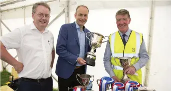  ??  ?? Micéal Martin TD, Leader of the Fianna Fail Party, with Michael Moynihan TD, and Cllr. Ian Doyle, Deputy Mayor of Cork County with the trophies for the horse section.