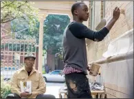  ??  ?? Aspiring artist Miles (Moonlight star Ashton Sanders) works on a mural as his mentor Robert McCall (Denzel Washington) looks on in Antoine Fuqua’s The Equalizer 2.