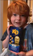  ?? The Canadian Press ?? Everett Botwright holds a package of Star Wars Kraft Dinner in Nanaimo, B.C., in a family handout photo. Hundreds of boxes of the limited-edition pasta now fill the home of the family in Nanaimo following a plea to help their autistic son.