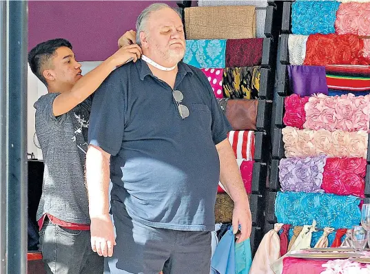  ??  ?? Thomas Markle, soon to be embraced by the Royal family, caused a stir when he was photograph­ed in public places looking at pictures of his daughter and getting himself measured up for a suit