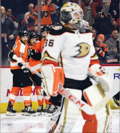  ?? DERIK HAMILTON — THE ASSOCIATED PRESS ?? Philadelph­ia Flyers’ Claude Giroux, left, celebrates with teammates after scoring a goal past Anaheim goaltender John Gibson during the second period.