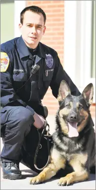  ?? Hearst Connecticu­t Media file photo ?? Danbury Police Officer Travis Kupchok crouches with Koda, his canine partner, in 2012.