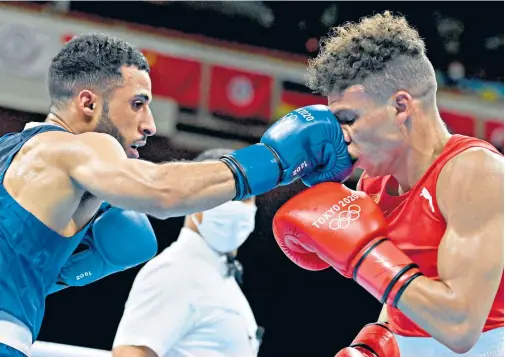  ??  ?? Feel the force: Galal Yafai (left) lands a blow on Cuba’s Yosbany Veitia on the way to his flyweight semi-final victory; Pat Mccormack (below) shows off his medal
Britain’s Olympic boxing medal hauls